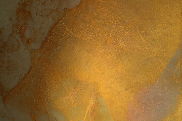 Golden grunge background of shiny paint stains.