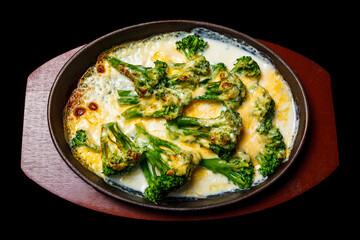 Close-up of omelet (omelette / scrambled eggs) with cauliflower on a plate on the brown wooden tray isolated on the black background. Top view