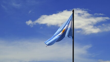 The Argentine flag on the mast against the cloudy sky.