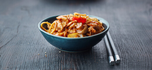 fried noodles and vegetables with hot chicken sauce