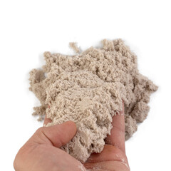 Hand and kinetic sand isolated on white background.
