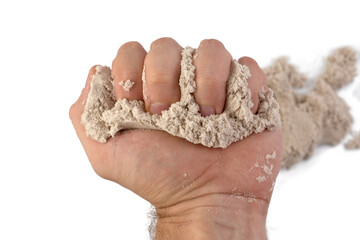 Hand and kinetic sand isolated on white background.