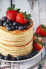 A stack if home-made pancakes with berry