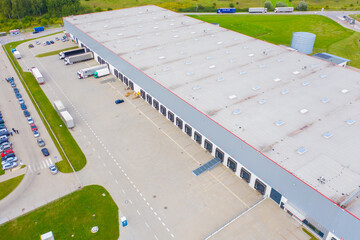Aerial view of goods warehouse. Logistics center in industrial city zone from drone view....