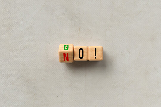 cubes turning message NO to GO on paper background