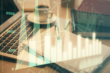 Double exposure of forex chart drawing and desktop with coffee and items on table background. Concept of financial market trading