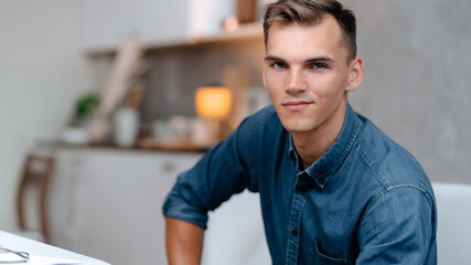 Obraz premium young man sitting in a home chair.