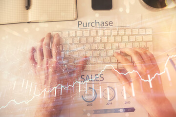 Double exposure of man's hands typing over laptop keyboard and forex chart hologram drawing. Top view. Financial markets concept.