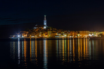 Picture of the illuminated historic part of Rovinj at night
