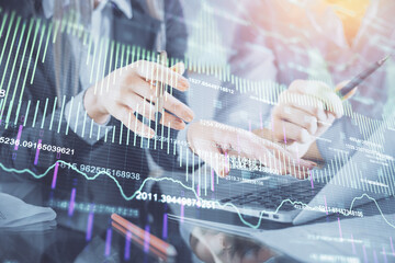 Multi exposure of man and woman working together and financial chart hologram. Business concept. Computer background.