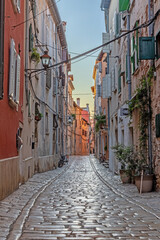 Scene of a cobblestoned street in the historic center of Rovinj in Croatia during sunrise