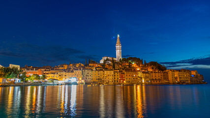 Fototapeta na wymiar View to the historic center of Rovinj during sunset with water reflections