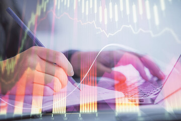 Double exposure of businesswoman hands typing on computer and forex chart hologram drawing. Financial analysis concept.