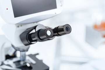 background image of a microscope on a table in the laboratory.