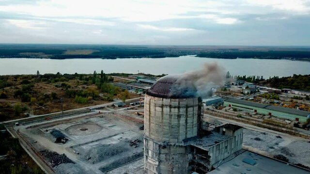 Demolition of old industrial building by exploding dynamite, aerial view