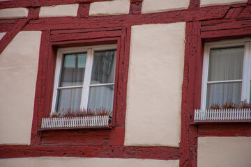 Fototapeta na wymiar wall of an old house in a small German town with windows