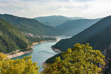 Lake Piva or Pivsko jezero artificial lake result of the construction of Mratinje Dam on the Piva river, Montenegro. View to Pluzine town from top of serpentine road.