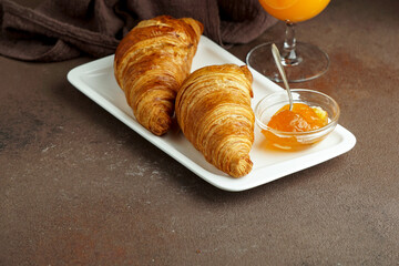 croissants with fresh orange juice and jam, tipical cotinental breakfast