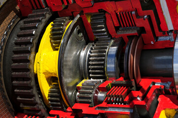 Bulldozer drive gear mechanism cross section, sprockets, bearings of diesel engine, large construction machine of red and yellow colors, heavy industry