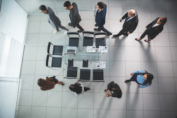 top view. a group of business people goes to the conference room