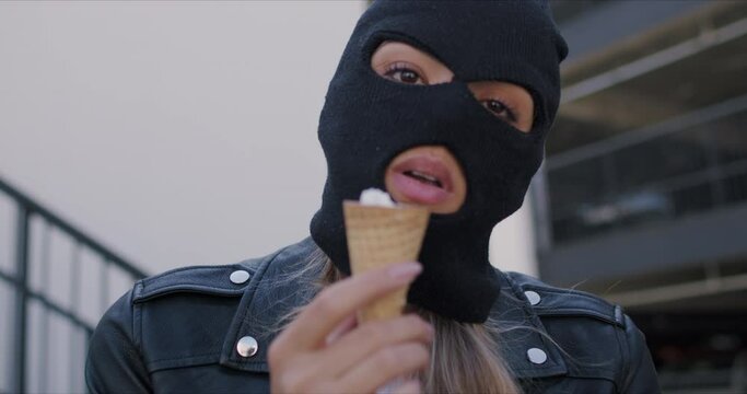 Woman wearing black balaclava and leather jacket
