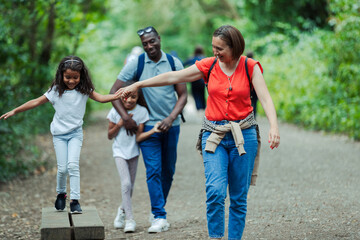 Happy family walking on park trail