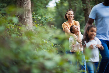 Happy family hiking in woods