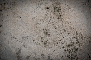 Grunge style. Close-up photo of concrete texture detail, There is a vignette at the corner of the image and a bright spot in the center is a copyspace. The gray and dark cement background is old.