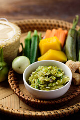 Northern Thai food (Nam Prik Num), Spicy young green chili dip eating with boiled vegetables, fresh vegetables and pork rind, Local Thai food