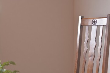 zoom in back of a antique oak chair.soft focus image. This expensive furniture is made in England. blurred background with copy space.