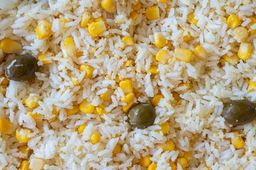 close up on rice, corn and olives, top view