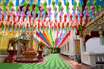 Obraz na płótnie Canvas Colorful paper lanterns Lanna style hanging for worship or respect of buddha in Wat Phra That Hariphunchai, northern of Thailand