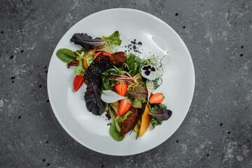 Salad with duck breast. Su-view duck fried in Teriyaki sauce, caramelized pear, tomatoes, salad mix, citrus sauce. copyright place
