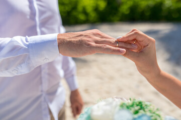 Close up view of ring exchange at the wedding ceremony on the paradise beach, Punta Cana, Dominican Republic 