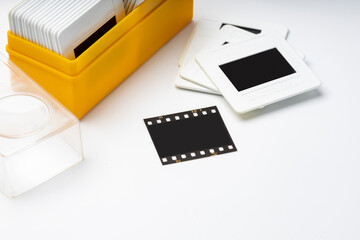 Close up of 35mm slide film and box on white background , Analog vintage records of memories in 1970s