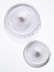 Cosmetic creams on white background