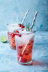 Glasses of fresh mojito cocktail with red currant on table