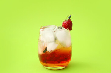 Glass of fresh mojito cocktail with berries on color background