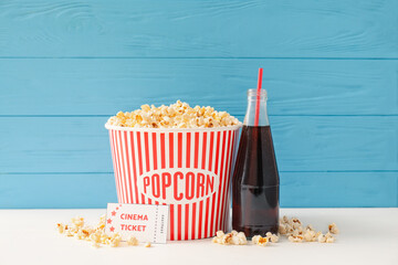 Composition with popcorn, cola and cinema tickets on table