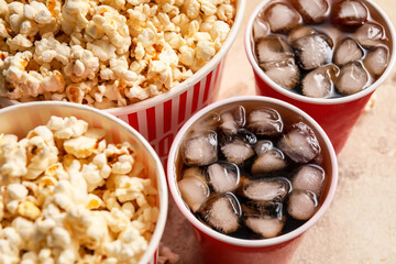 Tasty popcorn and cola on table, closeup