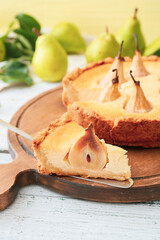 Board with tasty pear cake on table
