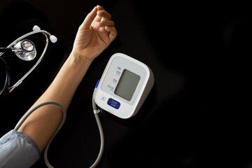  hand measuring blood pressure by using digital sphygmomanometer