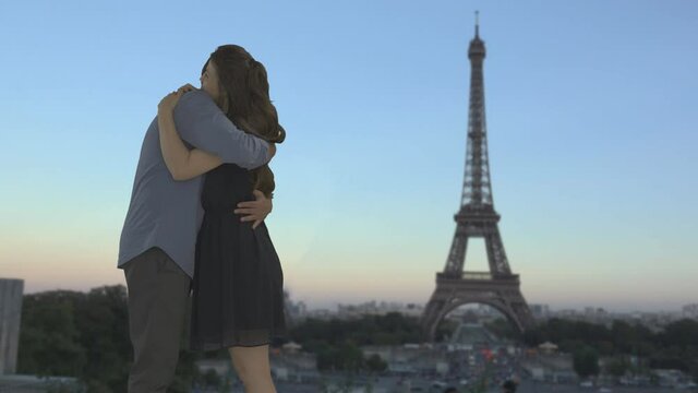 Couple dating kissing and embracing, sunset at Eiffel tour, romantic landmark
