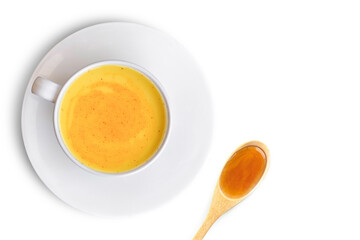 Closeup cup of golden milk ( turmeric latte tea )and pure honey in wooden spoon isolated on white...
