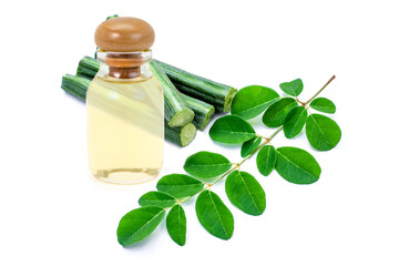 Moringa leaf with bottle of maluggay essential oil isolated on white background.