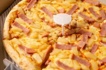 Close up. hawaiian pizza in the pizza package.