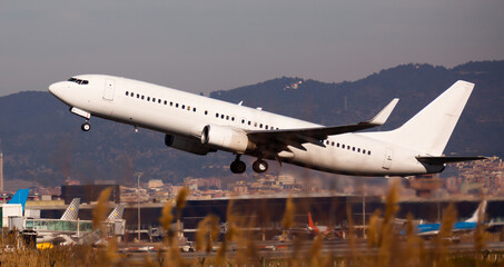 Obraz na płótnie Canvas Take off passenger plane in the sky. Airport Barcelona. High quality photo