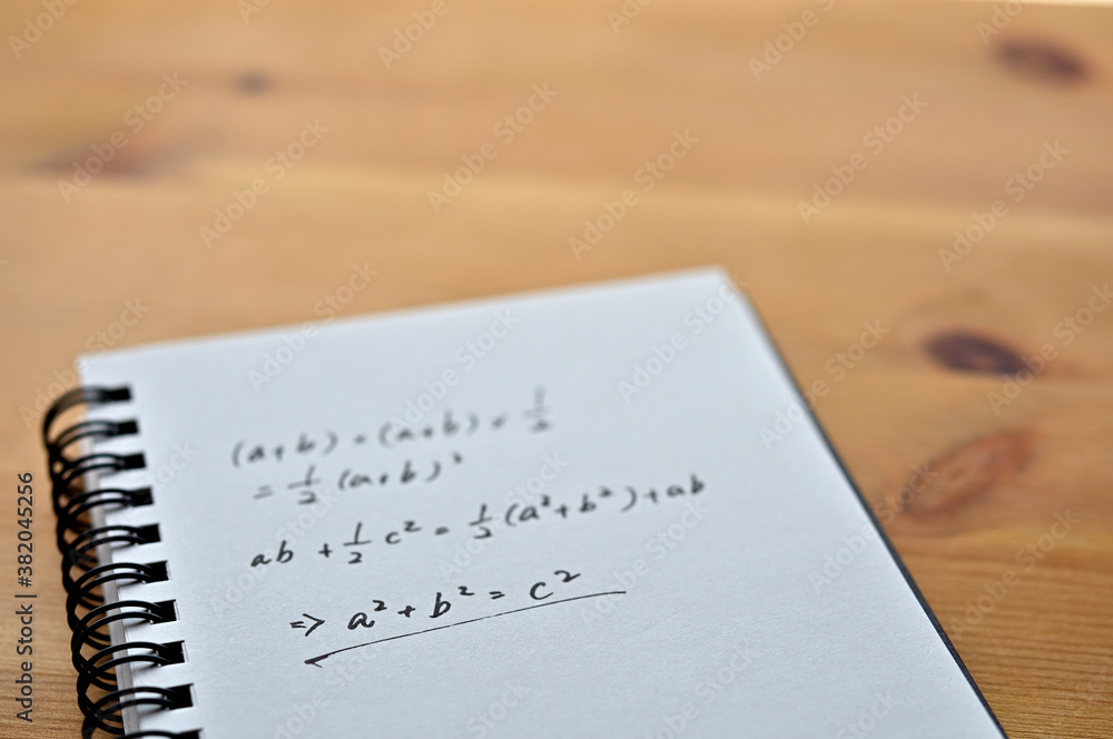 Poster a notebook with the formula for the pythagorean theorem sits by the window.