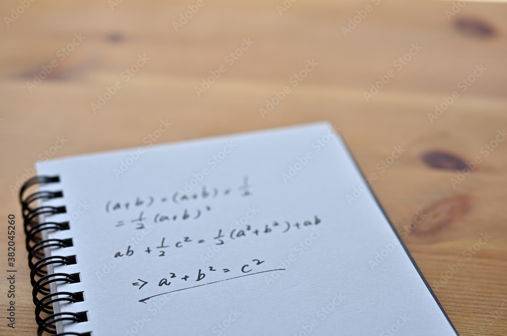 Poster a notebook with the formula for the pythagorean theorem sits by the window.