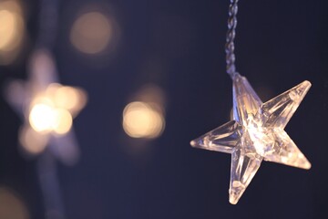 Christmas New Year Holidays Background.Shining star on dark blue blurred background. festive...